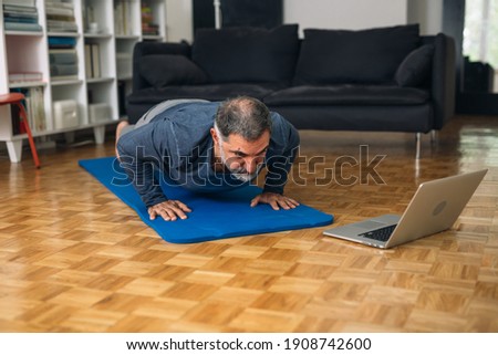 middle aged man training in his home