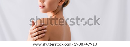 partial view of young woman touching bare shoulders, banner Royalty-Free Stock Photo #1908747910