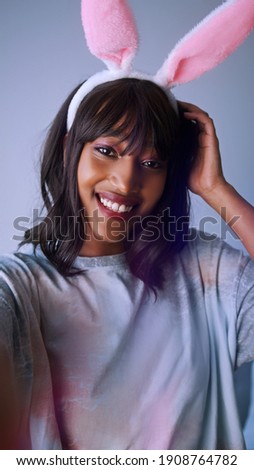 Portrait of young african american woman with rabbit ears. High quality photo