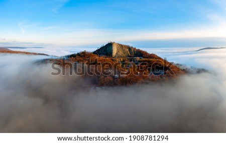Amazing geological formatoion with fog. Basalt columns hill in upper Balaton region in Hungary. The hungarian name is Hegyesstu.