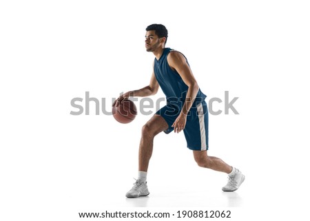 Strategy. Young arabian muscular basketball player in action, motion isolated on white background. Concept of sport, movement, energy and dynamic, healthy lifestyle. Training, practicing. Royalty-Free Stock Photo #1908812062