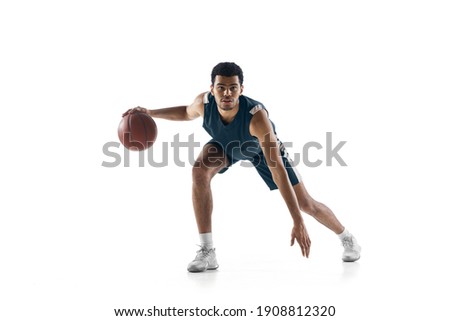 Competitive. Young arabian muscular basketball player in action, motion isolated on white background. Concept of sport, movement, energy and dynamic, healthy lifestyle. Training, practicing. Royalty-Free Stock Photo #1908812320