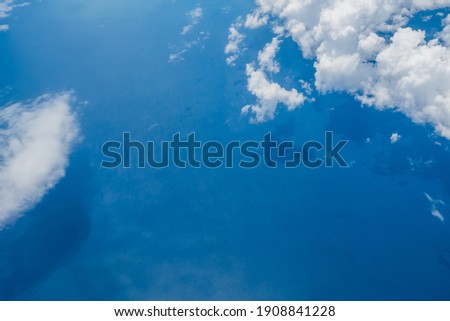 Aerial view scene of the sea or ocean which hiding under white fluffy clouds. Royalty-Free Stock Photo #1908841228