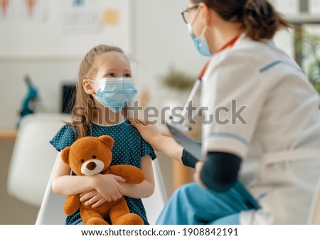 Doctor and child wearing facemasks during coronavirus and flu outbreak. Virus protection. COVID-2019. Taking on masks. Royalty-Free Stock Photo #1908842191