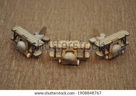 Close up creative shots of small wooden plane models handcrafted from wood, around 3cm X 2cm in size