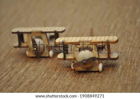 Close up creative shots of small wooden plane models handcrafted from wood, around 3cm X 2cm in size