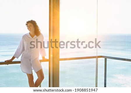 Photo of attractive woman enjoying balcony view at home Royalty-Free Stock Photo #1908851947