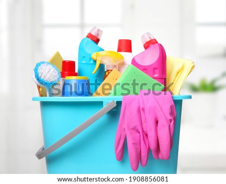 Sanitary bottles,desinfectants in plastic bucket.Housework supplies.Domestic chemical items. Royalty-Free Stock Photo #1908856081