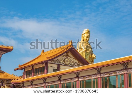Guanyin goddress with temple rooftop and beautiful sky at foguangshan thaihua temple thailand.Fo Guang Shan is one of the four large Buddhist organizations in Taiwan