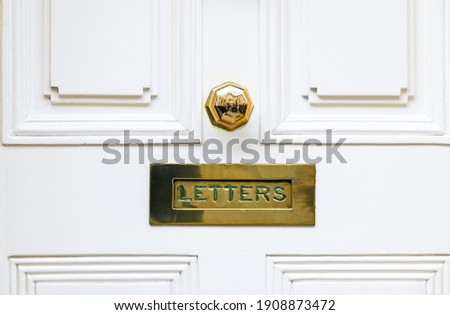 White wooden door and letter box close up for conceptual use.