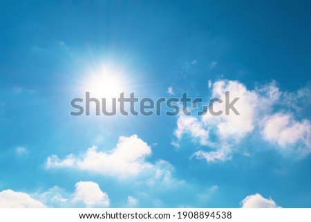 Bright blue sky and sun flare in spring sky with clouds vapor Royalty-Free Stock Photo #1908894538