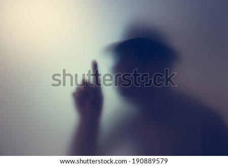 Shadowy figure behind glass  Royalty-Free Stock Photo #190889579