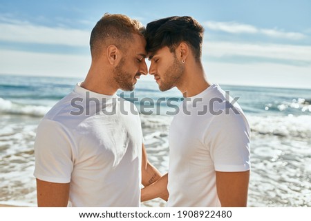 Romantic young gay couple at the beach. Royalty-Free Stock Photo #1908922480