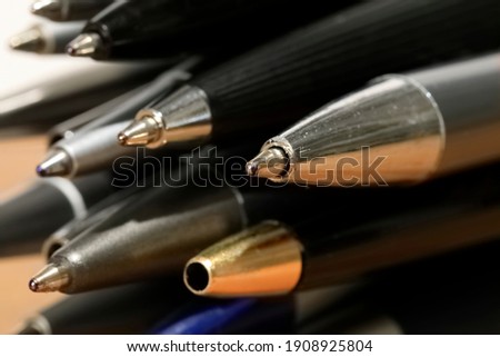 Some miscellaneous used ball pens in a pile. Office accessories. Royalty-Free Stock Photo #1908925804