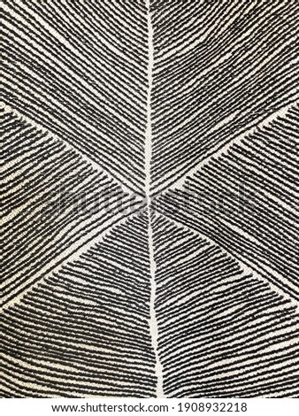 Geometric texture background with hand drawn abstract black and white lines or triangles on textile for use as graphic resources, wallpaper, decor, or background pattern Royalty-Free Stock Photo #1908932218