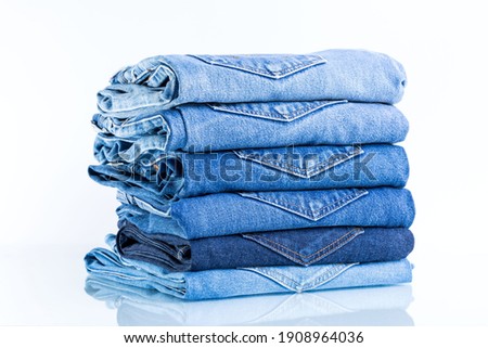 
Jeans trousers stack on white background.concept  jean in supermarket. Royalty-Free Stock Photo #1908964036