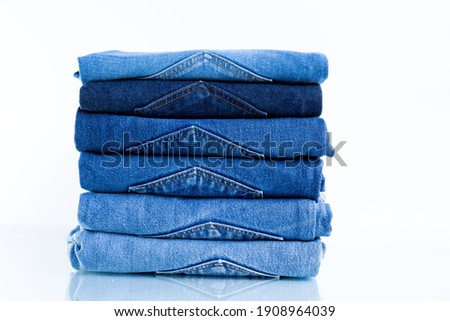 
Jeans trousers stack on white background.concept  jean in supermarket. Royalty-Free Stock Photo #1908964039