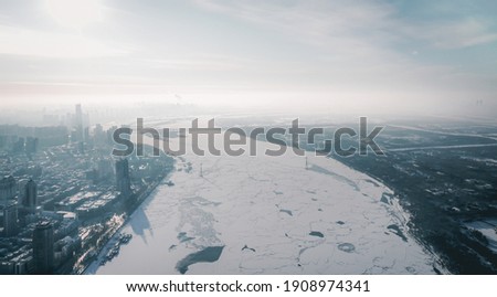 drone picture of Harbin city view, winter ice shooting, bridge, frozen river, China