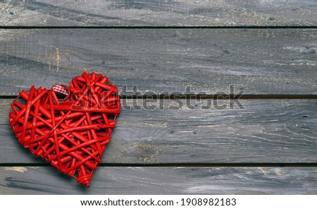  Red shape heart on an old vintage wooden grey background. Happy Valentines Day background. Love concept. Top view.                         