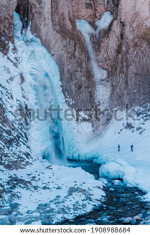 Photo of the Jily Su waterfall in winter. Landscape of mountains with a waterfall. 