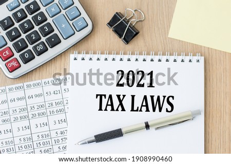 words TAX LAWS 2021 on a white notepad on the table. Business concept.