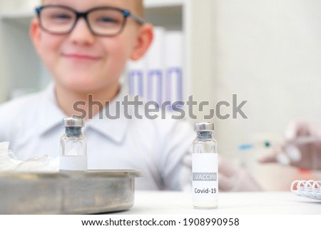Little boy receiving a vaccination at the clinic against the covid 19 coronavirus, close up. Virus prevention