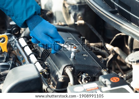 Car repair close up in auto repair shop Royalty-Free Stock Photo #1908991105
