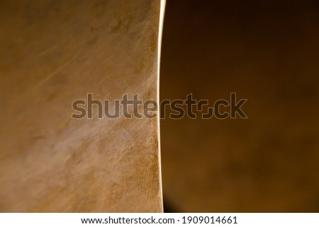 Part of the bronze ship propeller, closeup. Abstract, scratched, bronze texture.