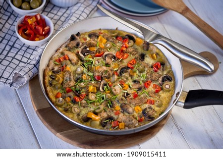 Frittata pizza. Delicious and healthy breakfast. Baked eggs with vegetables and cheese. Eggs with pepper, onion, and garlic. Keto pizza.