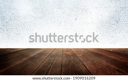 Empty Interior room with old white concrete or plaster wall, wooden plank floor, used as studio background wall to display your products. Space for text and picture. Design ideas and style.