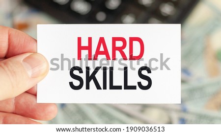 Motivational words: HARD SKILLS. Man holds a piece of paper with the text: HARD SKILLS. Business and finance concept