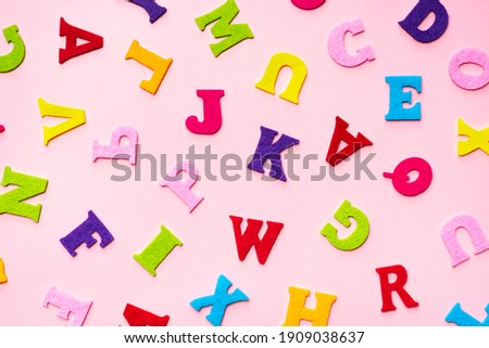 English alphabet letters on pink background pattern.
