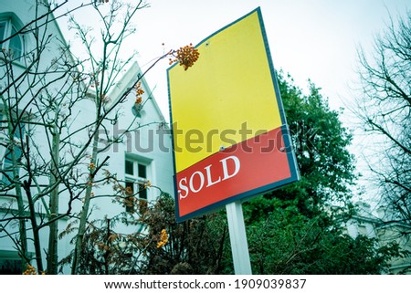 Estate Agent  'Sold' sign on urban UK street
