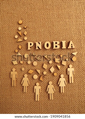 mental illness-phobia in the form of wooden letters and figures of people on a jute background. High quality photo