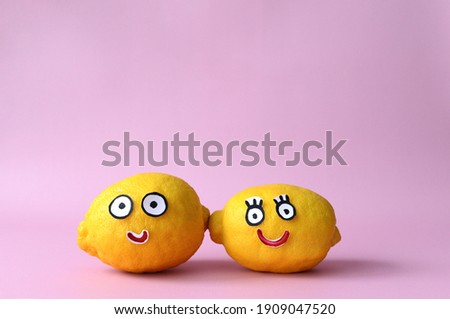 Two funny cartoon lemons, couple in love on pink isolated background. Drawn eyes. Ingredients.