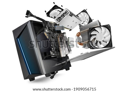 flying parts of a modern computer. hardware components mainboard cpu processor graphic card RAM cables and cooling fan flying out of black blue PC case on isolated abstract technology background Royalty-Free Stock Photo #1909056715