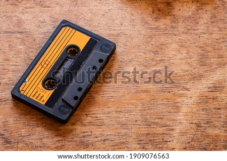 Old cassette tape on a wood table Royalty-Free Stock Photo #1909076563
