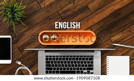 stylized loading bar with the word ENGLISH and office equipment on wooden background