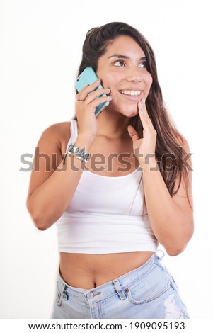 A young pretty female talking on her phone and smiling