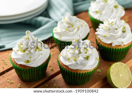 Tasty cupcakes with lemon on a wooden table. Image with selective focus.