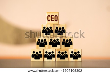 organization and team structure symbolized with cubes and a hand putting a cube with the German word for Let's Go at the top tier Royalty-Free Stock Photo #1909106302