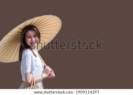 Asian woman spreading a paper umbrella isolated from the background