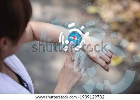 close up hand of woman point finger at smartwatch screen checking measuring heart rate after exercise. 