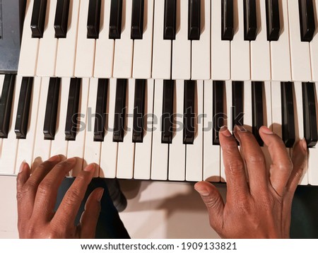 a person playing the piano close up, playing the piano