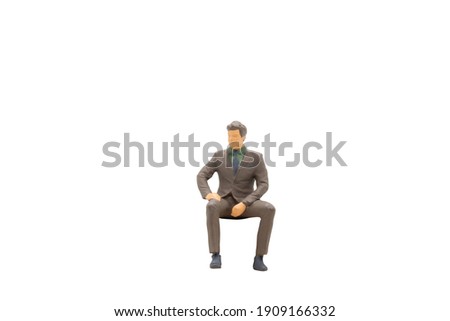 Miniature people Businessman sitting isolated on white background with clipping path Royalty-Free Stock Photo #1909166332