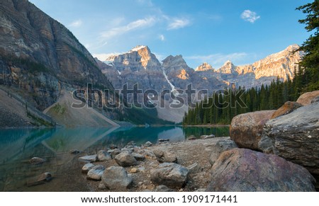 A beautiful calm summer morning at the glacial blue waters of Moraine Lake in Banff National Park, Alberta, Canada. 