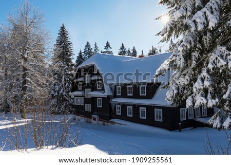 The beautiful Chalet Serlissky Mlyn located in the Eagle Mountains, near to the famous ski resort of Destne v Orlickych horach in the north of the Czech Republic during sunny day in winter season.