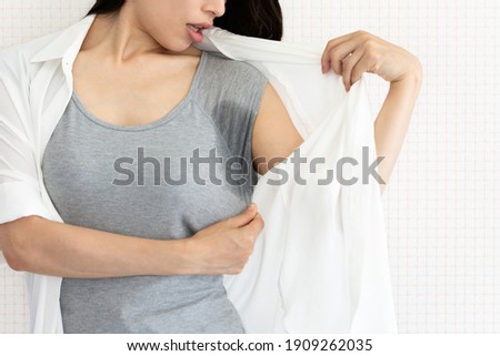 The woman is checking her armpit sweat. Royalty-Free Stock Photo #1909262035
