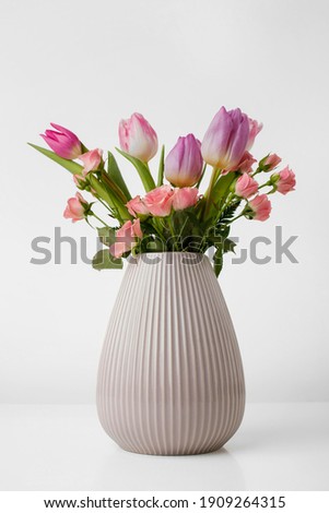 
vase with magnolia flowers isolated on white background.

