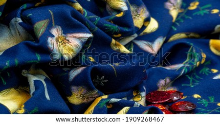 Cotton, blue background with a print of bunnies and fruits. The jersey fabric is so named because it was first produced in the Middle Ages on the Channel Island of Jersey.